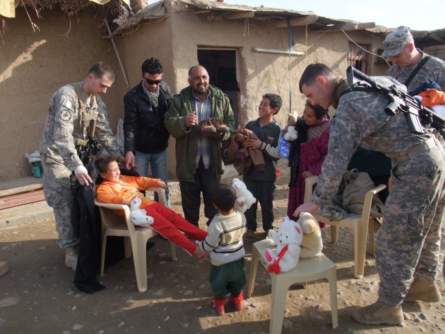 CONTINGENCY OPERATING LOCATION Q-WEST, Iraq -Soldiers with A Company, 2nd Battalion, 198th Combined Arms, 155th Brigade Combat Team, out of Hernando, Miss., give clothing and other items to Khalil Abrahim, and his family at his home near Al Qayarrah,...