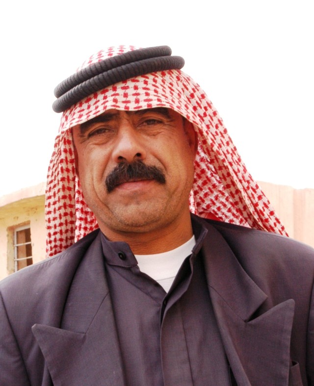 CONTINGENCY OPERATING LOCATION Q-WEST, Iraq - Ibrahim Hawaas Madlul, the mukhtar or village leader of Jedallah Anuk, a small community near Q-West, poses in the village schoolyard during a humanitarian mission conducted by Mississippi Guardsman...