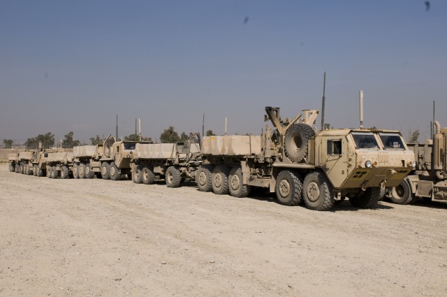 Trucks carrying concrete barriers sit waiting for nightfall, Feb. 25 at Contingency Operating Base Marez, Iraq. Each night, Soldiers with the 733rd Transportation Company, 395th Combat Sustainment Support Battalion, 15th Sustainment Brigade, 13th Sus...