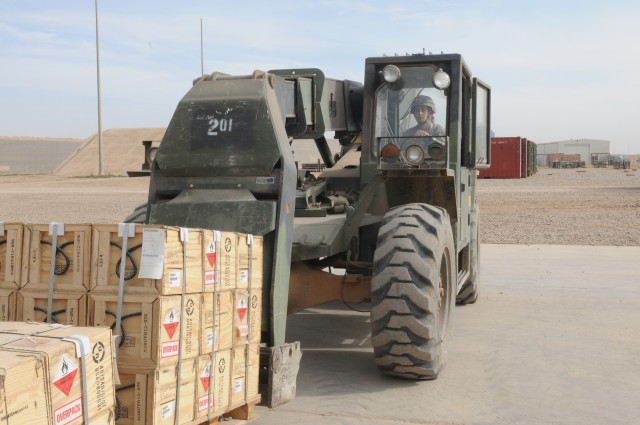 Spc. Robert Grasse, an ammunition storage processer with the 63rd Ordnance Company, 80th Ordnance Battalion, 15th Sustainment Brigade, 13th Sustainment Command (Expeditionary) and a Gardner, Maine, native, uses a forklift to move crates of munitions ...