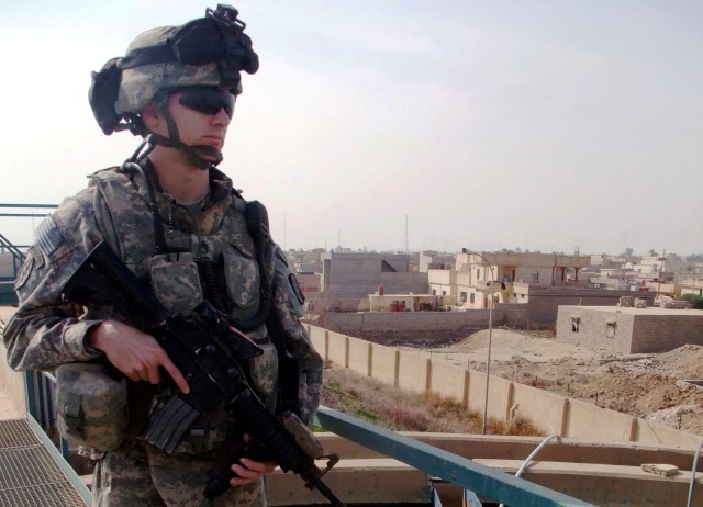 CONTINGENCY OPERATING LOCATION Q-WEST, Iraq - Staff Sgt. Benjamin P. Wills, a squad leader from Southaven, Miss., scans the rooftops and back alleys of Al Qayarrah from the water filtration plant the serves COL Q-West during a routine patrol to...