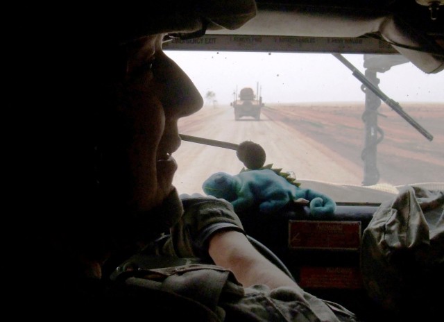 CONTINGENCY OPERATING LOCATION Q-WEST, Iraq -Spc. Jackie L. Johnson, III, a gun truck driver with A Company, 2nd Battalion, 198th Combined Arms, 155th Brigade Combat Team, out of Hernando, Miss., carries a stuffed toy reptile on the dash of his...