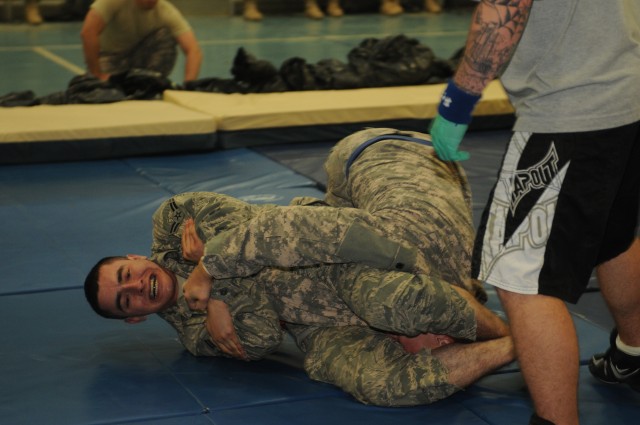 Air Force Airman 1st Class Raymond Elizalde, a force protection escort with the 332nd Expeditionary Force Protection Squadron and an Imperial, Calif., native, puts his opponent into an arm bar during a match at 80th Ordnance Battalion's 'Phoenix Supp...