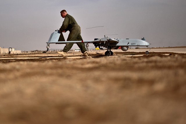 CAMP TAJI, Iraq - After a Shadow unmanned aerial vehicle makes its landing, Spc. Ben Hughes, from Fort Drum, N.Y., a Shadow UAV maintainer in 2nd Brigade Special Troops Battalion, 2nd Brigade Combat Team, 10th Mountain Division, U.S. Division-Center,...