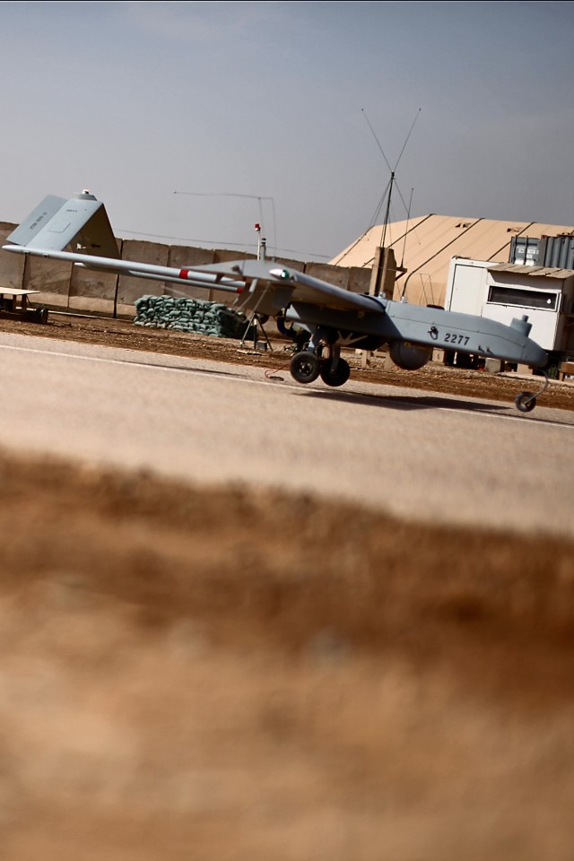 CAMP TAJI, Iraq - A Shadow unmanned aerial vehicle is about to touch down, marking a momentous occasion for the operators and maintainers of 10th Mountain Division, 3rd Infantry Division and 2nd Infantry Division, all of whom fall under Company G, 2n...