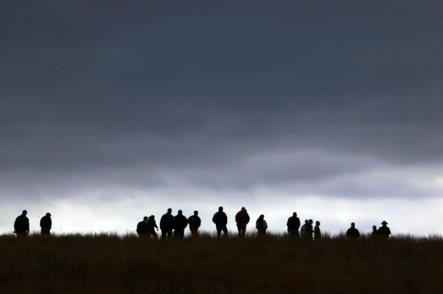 Fort Sill Air Defense Artillery Captains' Career Course students and National Park Service rangers are silhouetted against a threatening Oklahoma sky Friday, Mar. 5, 2010, at the Washita Battlefield National Historic Site near Cheyenne, Okla. The ADA...