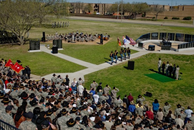 FORT HOOD, Texas-All in attendance rise and render proper respect to the Nation's Colors carried by the 1st Cavalry Division's Honor Guard as they enter the 1st Cav. Div. OIF Memorial Rededication Ceremony. The ceremony, held here at Fort Hood, was t...