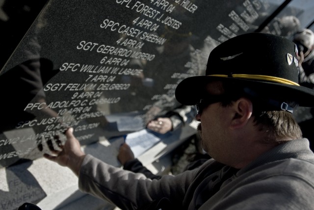 FORT HOOD, Texas-Family members locate their loved ones names on the walls of the 1st Cavalry Division's Operation Iraqi Freedom Memorial at the division's headquarters, here, at Fort Hood March, 12. Each of the 69 individual names added were called ...