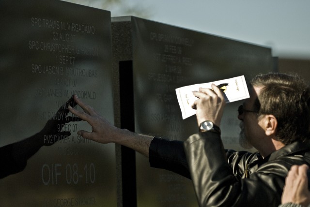 FORT HOOD, Texas-Family members locate their loved ones names on the walls of the 1st Cavalry Division's Operation Iraqi Freedom Memorial at the division's headquarters, here, at Fort Hood March, 12. Each of the 69 individual names added were called ...