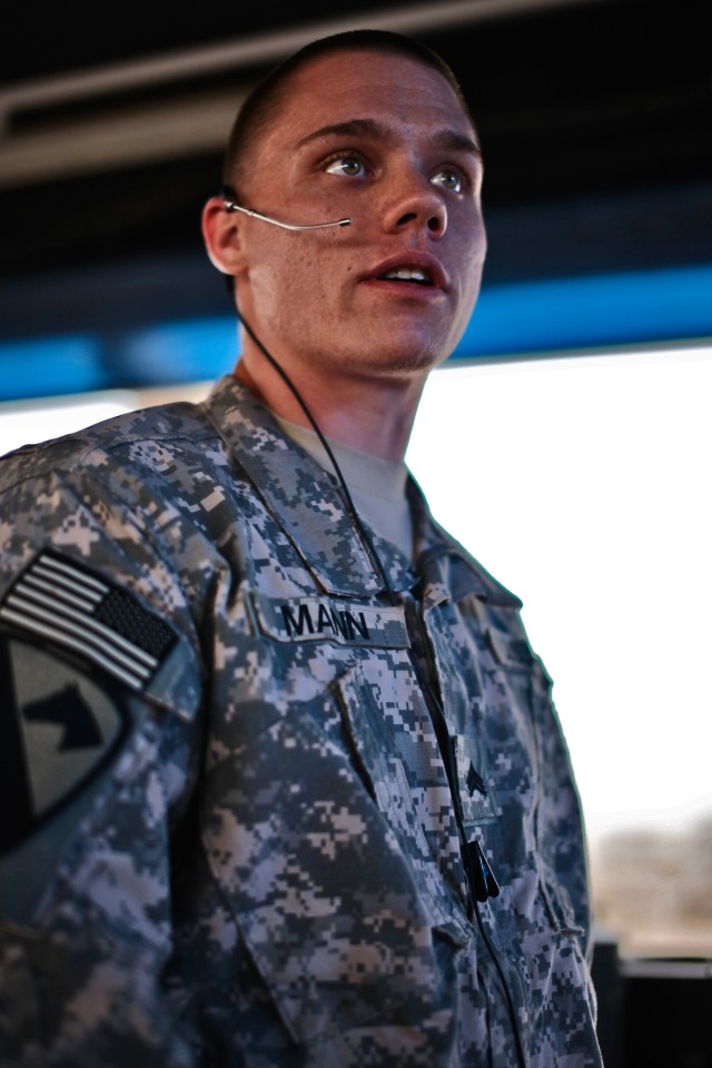 CAMP TAJI, Iraq - Sgt. Joseph Mann, from Philadelphia, an air traffic controller for Company F, 2nd Battalion, 227th Aviation Regiment, 1st Air Cavalry Brigade, 1st Cavalry Division, U.S. Division-Center, directs traffic at the Taji airfield, March 1...