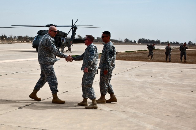 CAMP TAJI, Iraq - Shortly after arriving on Taji airfield, Gen. Ray Odierno (left), from Rockaway, N.J., commanding general, U.S. Forces - Iraq, shakes the hand of Col. Douglas Gabram (center), from Cleveland, Ohio, commander, 1st Air Cavalry Brigade...