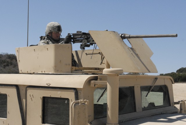 FORT HOOD, Texas-Pfc. Lucas Halter, a combat engineer assigned to 4th Brigade Special Troops Battalion, 4th Brigade Combat Team, 1st Cavalry Division uses a .50 caliber machine gun to engage the targets during the battalion's armored humvee ...