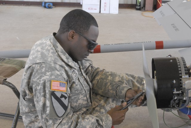 FORT HOOD, Texas-Sgt. Antonio Mccloud, an unmanned aerial vehicle maintainer assigned to Alpha Company's Tactical Unmanned Aerial System, 4th Brigade Special Troops Battalion, 1st Cavalry Division, conducts pre-flight checks on a unmanned aerial...