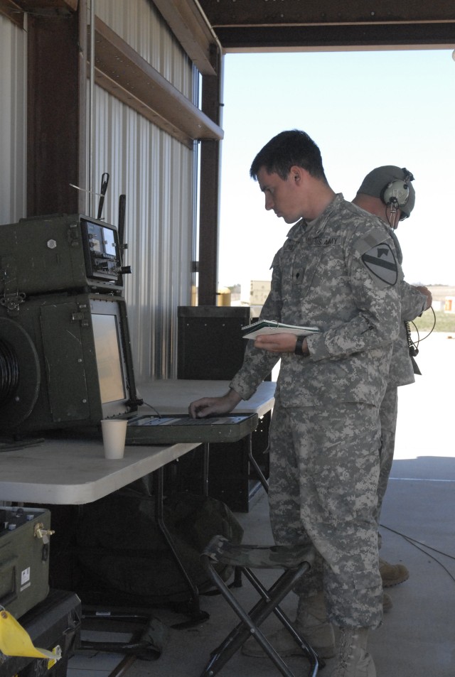 FORT HOOD, Texas-Spc. Stephen Rayleigh, an unmanned aerial field operator assigned to Alpha Company's Tactical Unmanned Aerial System, 4th Brigade Special Troops Battalion, 1st Cavalry Division conducts system checks in preparation for takeoff...