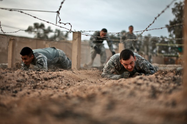 CAMP TAJI, Iraq - During a team-building challenge, 1st Lt. Alan Roy (right), a platoon leader from Strawberry, Minn., and Sgt. Luis Garcia, a squad leader from Bryant, Texas, both of whom are in Company F, 3rd Battalion, 227th Aviation Regiment,...