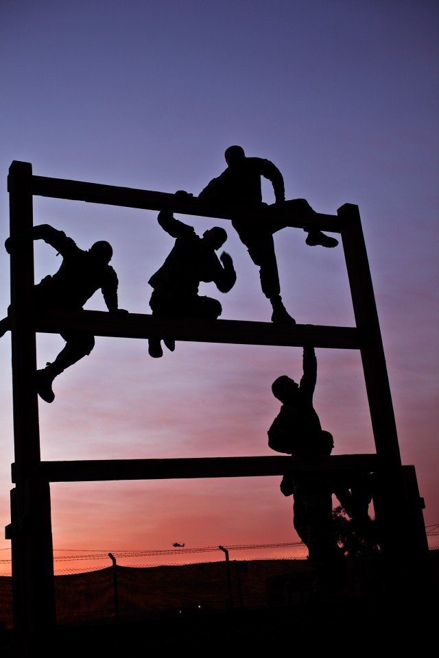 CAMP TAJI, Iraq - As the sun rises, Soldiers from Company F, 3rd Battalion, 227th Aviation Regiment, 1st Air Cavalry Brigade, 1st Cavalry Division, U.S. Division-Center, make their way through an obstacle course March 23. The second of eight events, ...