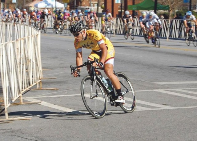 Jose Solis Jr. rounds a corner in a category 3 criterium race March 6 in Albany, Ga. This is one of many races Solis races in on the weekends with his dad, LTC Jose Solis, of WHINSEC. Solis Jr., 22, has been selected to race on the Puerto Rico...