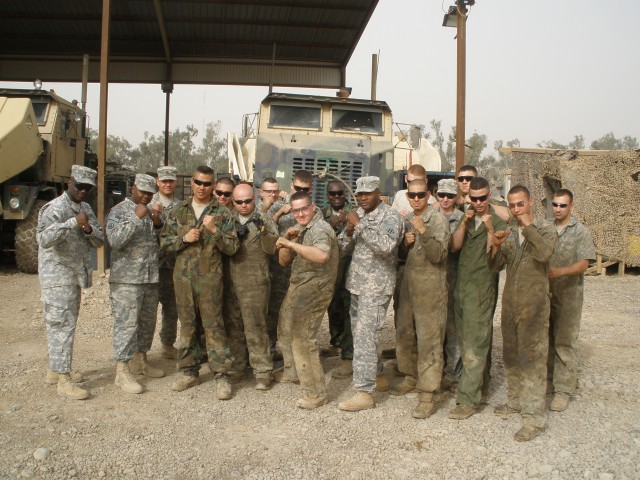 CAMP LIBERTY, Iraq - Soldiers of the Heavy Equipment Transport Tiger Team, 1st Maintenance Company, 260th Combat Service Support Battalion, 15th Sustainment Brigade, pose with Command Sgt. Maj. Jesse Andrews, the 3rd Infantry Division and United...