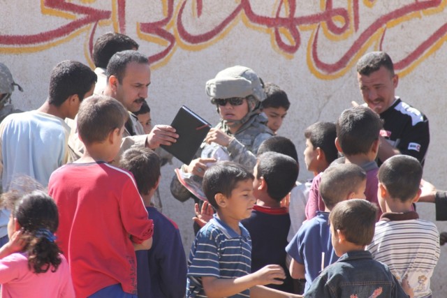 Spc. Zandrast R. Rast, a supply clerk with the 3666th Support Maintenance Company, 541st Combat Sustainment Support Battalion, 15th Sustainment Brigade, 13th Sustainment Command (Expeditionary), talks to locals during a humanitarian aid mission near ...