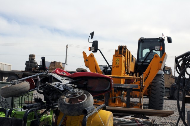A forklift places excess equipment down by a turned-in mini-bike here March 23, as part of the 15th Sustainment Brigade, 13th Sustainment Command (Expeditionary)'s, ongoing effort to drawdown U.S. military forces in the unit's area of operations - no...