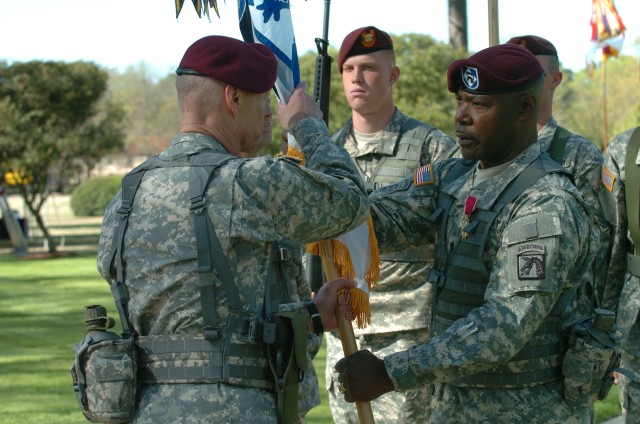Outgoing Command Sgt. Maj. Joseph R. Allen passes the XVIII Airborne Corps to Lt. Gen. Frank Helmick