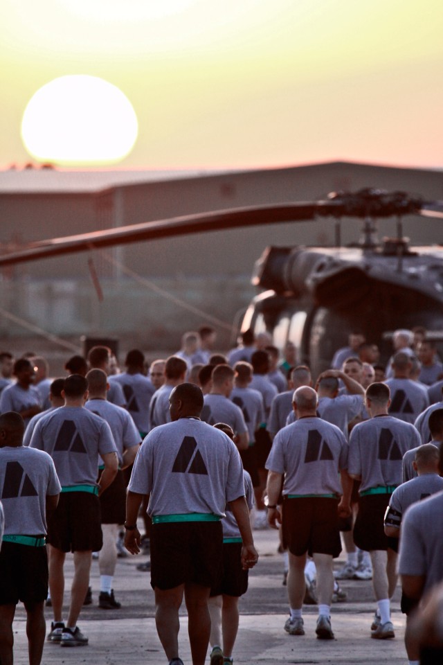 CAMP TAJI, Iraq - Noncommissioned officers of 1st Air Cavalry Brigade, 1st Cavalry Division, U.S. Division - Center, gather under the rising sun, March 31, before taking part in an NCO run to build esprit de corps as they prepare for redeployment mid...