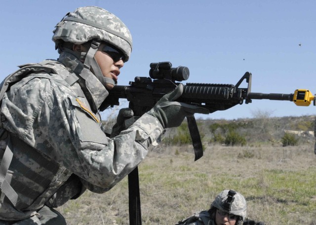 FORT HOOD, Texas-Pfc. Eddsion Walker, a scout assigned to the 2nd Battalion, 12th Regiment, 4th Brigade Combat Team, 1st Cavalry Division demonstrates suppressive fire during fire team training at the Owl Creek Assault Course, March 29. Walker, a nat...