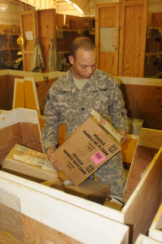 Spc. Elwin Crowner, the high-item-priority manager with the 716th Quartermaster Company, 80th Ordnance Battalion, 15th Sustainment Brigade, 13th Sustainment Command (Expeditionary) and an Annapolis, Md., native, moves boxes at the Supply Support Acti...