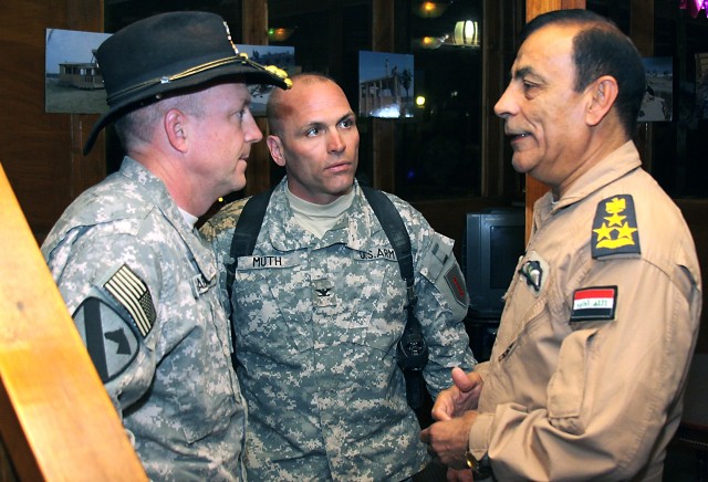 CAMP TAJI, Iraq - Col. Douglas Gabram (left) of Cleveland, Ohio, commander, 1st Air Cavalry Brigade, 1st Cavalry Division, and Col. Frank Muth (center) of Fort Riley, Kan., commander, Combat Aviation Brigade, 1st Infantry Division, listen as Iraqi Ai...