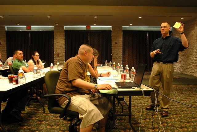 AUSTIN, Texas-Chaplain (Cpt.) Jay Hudson (right), 1st Battalion, 5th Cavalry Regiment, 2nd Brigade Combat Team, 1st Cavalry Division, demonstrates to a group of married couples how to use an "argument card" during a marriage retreat near Austin,...