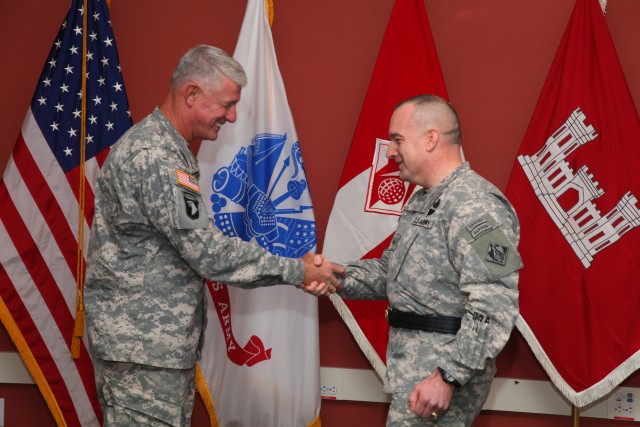 Lieutenant General shakes hands with newly promoted Brigadier General