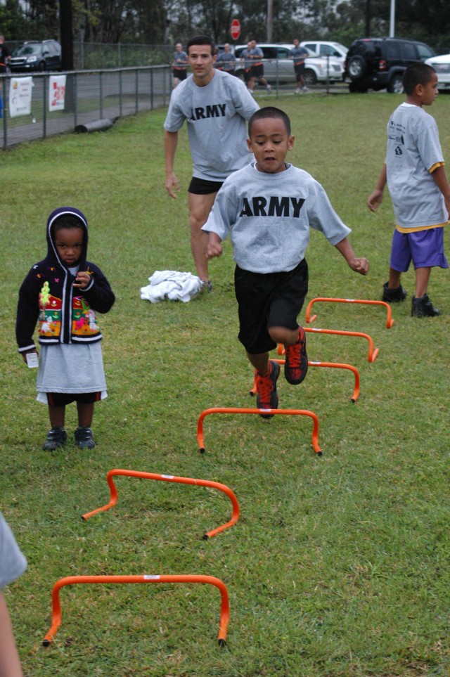 PT in the Park: Children and parents laugh, dance, run and jump through the rain