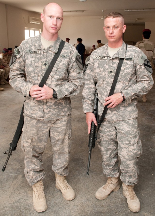 CAMP MEJID, Iraq - Spc. Christopher Howard, an Apache aircraft maintainer, and Spc. Michael Cooley, an aircraft frame repairer, both with 4-227th Attack Reconnaissance Battalion, 1st Air Cavalry Brigade, 1st Cavalry Division, stand in front of top...