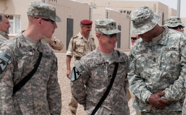 CAMP MEJID, Iraq - Spc. Christopher Howard, an Apache aircraft maintainer, and Spc. Michael Cooley, an aircraft frame repairer, both with 4-227th Attack Reconnaissance Battalion, 1st Air Cavalry Brigade, 1st Cavalry Division, talk with Command...