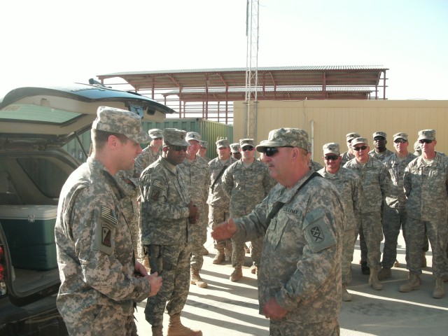 Chief Warrant Officer Pendley, Alabama, a maintenance warrant assigned to the 2025th Transportation Company, 264th Combat Sustainment Support Battalion, 15th Sustainment Brigade, 13th Sustainment Command (Expeditionary), receives a battalion coin...