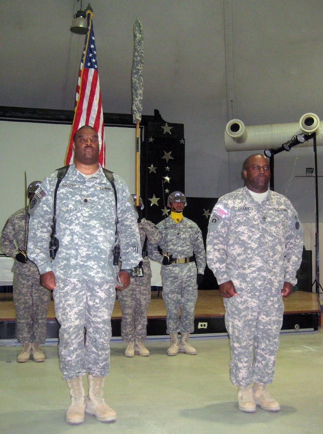 Lt. Col. Dennis E. Dockery, commander of the 395th Combat Sustainment Support Battalion and Command Sgt. Maj. Gerry-Jay James, the unit's senior noncommissioned officer, stand in front of their unit's cased colors at a ceremony at the Morale, Welfare...