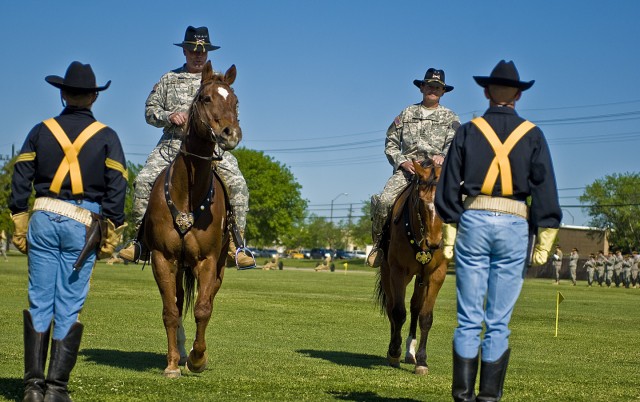 FORT HOOD, Texas-Soldiers from the 1st Cavalry Division's Horse Cavalry Detachment wait for reviewing officer, Gen. Charles Campbell (left), and the newest 1st Cavalry Division commander, Maj. Gen. Daniel Allyn, to dismount their horses after pass...