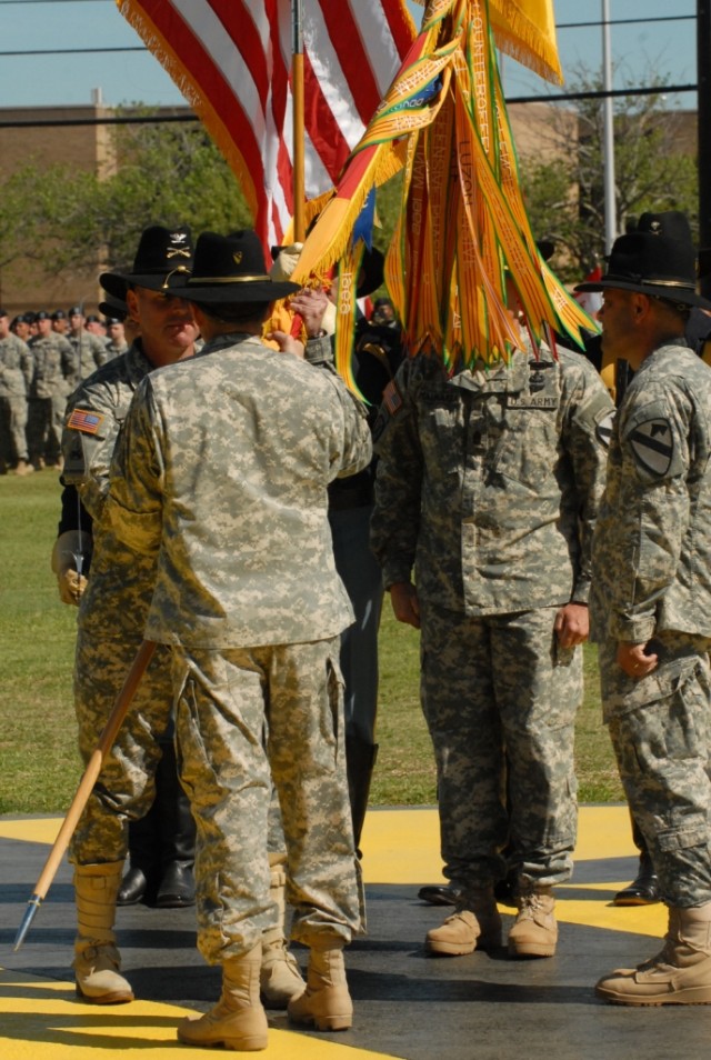 FORT HOOD, Texas-Col. John Peeler (left) accepts the 2nd Brigade Combat Team, 1st Cavalry Division colors from Maj. Gen. Daniel Allyn, the commander of the 1st Cav. Div., during 2nd BCT's change of command ceremony on Fort Hood, Texas, April 9. Peele...