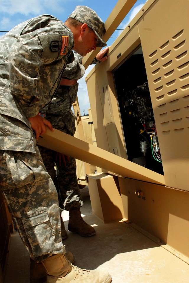 FORT HOOD, Texas-Spc. Joshua Martin (left) and Sgt. 1st Class James Cookman, both from the 41st Fires Brigade, check the generator on the new deployable rapid assembly shelter (DRASH) system, April 14. The new DRASH system and accessories come mounte...