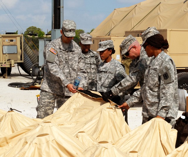 FORT HOOD, Texas-Soldiers from the 41st Fires Brigade examine the sides and Velcro of the new deployable rapid assembly shelter (DRASH) system, April 14. The new DRASH system will be used for field operations and the Soldiers are scheduled to validat...
