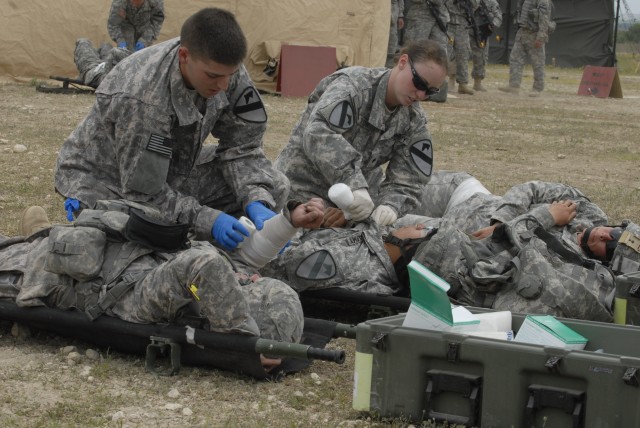 FORT HOOD, Texas - Soldiers assigned to the 27th Brigade Support Battalion, 4th Brigade Combat Team, 1st Cavalry Division, render aid to wounded troops during the unit's mass causality training event April 15. Troops conducting this training are...