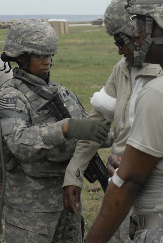 FORT HOOD, Texas - Staff Sgt. Kristal Wise, an emergency care non-commissioned officer assigned to the 27th Brigade Support Battalion, aids a "wounded" Soldier during the unit's mass causality training event April 15. Troops conducting this...
