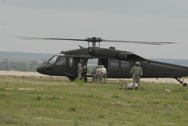 FORT HOOD, Texas - Wounded troops assigned to the 27th Brigade Support Battalion, 4th Brigade Combat Team, 1st Cavalry Division, prepare to be medically evacuated on a UH-60 Blackhawk during the unit's mass causality training event, here, April...