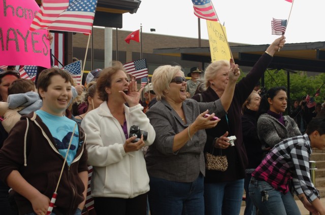 FORT HOOD, Texas-Family members cheer excitedly as buses containing 1st Air Cavalry Brigade service members, returning from Iraq, arrive at Cooper Field for a welcome home ceremony, April 19. The families had to wait longer than anticipated for the S...