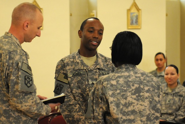 Sgt. Christopher Jones, a food service specialist with the 15th Sustainment Brigade, renews his vows to his wife during a ceremony April 13 at Contingency Operating Location Q-West, Iraq. (U.S. Army photo by Staff Sgt. Rob Strain, 15th Sustainment...