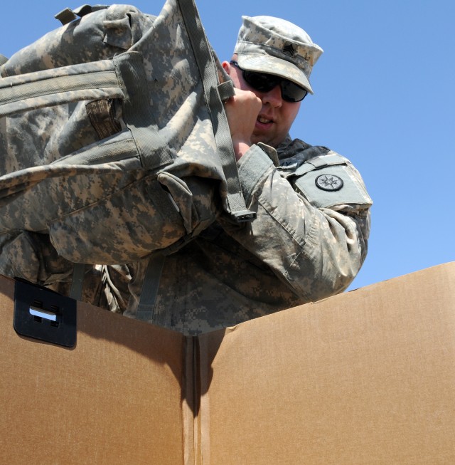 Sgt. Colin Pilch, a truck driver for 733rd Transportation Company, 15th Special Troops Battalion, 15th Sustainment Brigade, 13th Sustainment Command (Expeditionary), and Lynchburg, Va., native, places medical kits into a palletized box for turn in...