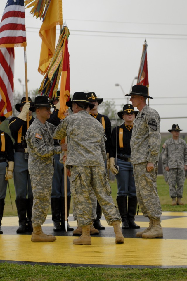 FORT HOOD, Texas-Col. Douglas Crissman (left), the commander for 3rd Brigade Combat Team, 1st Cavalry Division and a native of Burke, Va., receives the brigade's colors from Maj. Gen. Daniel Allyn, the commanding general of the division, during a...