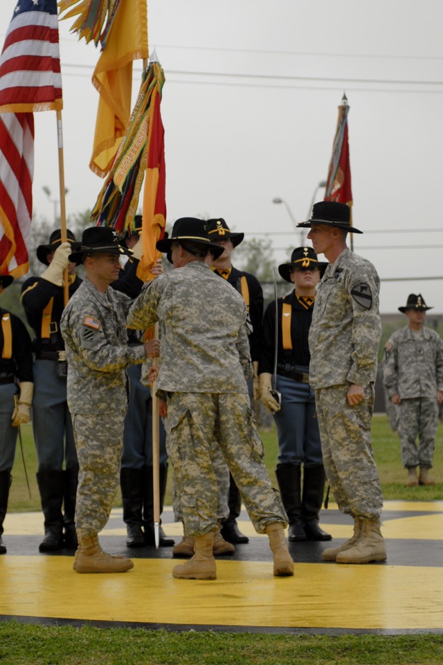 FORT HOOD, Texas-Col. Douglas Crissman (left), the commander for 3rd Brigade Combat Team, 1st Cavalry Division and a native of Burke, Va., receives the brigade's colors from Maj. Gen. Daniel Allyn, the commanding general of the division, during a cha...