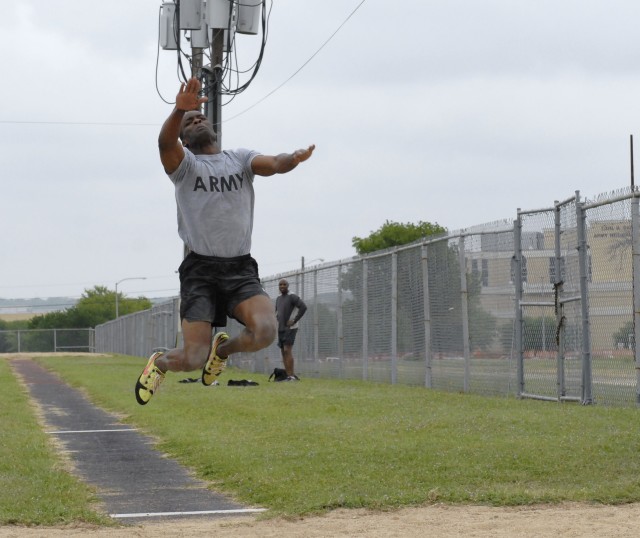 FORT HOOD, Texas-Maj. Sheldon Morris, the brigade assistant operations officer, from Headquarters and Headquarters Troop, 3rd Heavy Brigade Combat Team, 1st Cavalry Division, displays his form, as he jumps his way to victory in the long jump at Fort ...