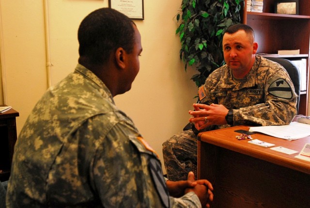 FOR HOOD, Texas-Sgt. 1st Class Robert Bee (right), a Rochester, Minn. native and an equal opportunity advisor for 2nd Brigade Combat Team, 1st Cavalry Division, talks with Spc. Darrell Robinson, a Pittsburg native and an infantry Soldier with A...
